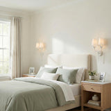 Alice Double Wall Sconce 21", Matte White leaf design Wall Sconce in a Transitional Bedroom with sage green bedding and beige headboard.