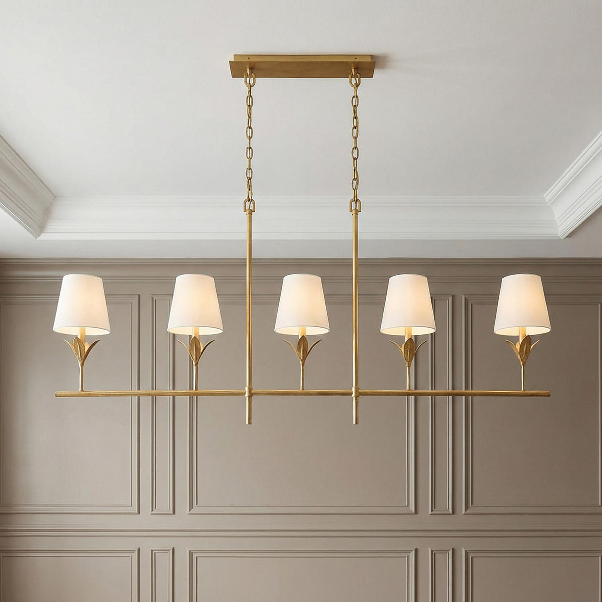 Alice 5 Light Linear Chandelier 53", Antique Gold leaf design Chandelier in a Transitional Dining Room with taupe wainscoting walls.