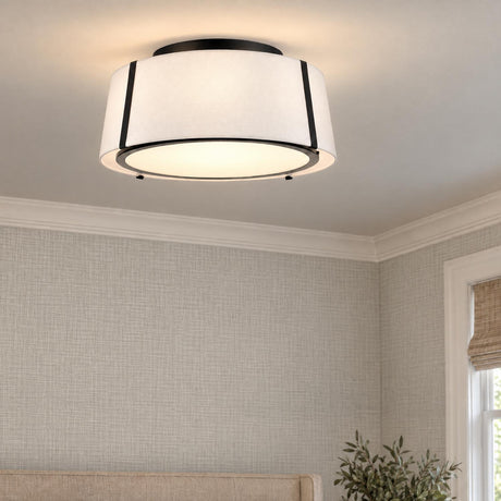 A transitional bedroom with the Hoyt Flush Mount 18", Black featuring a white fabric drum shade mounted on the ceiling above textured wallpaper and an upholstered headboard.