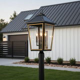 Ellington Outdoor Post Light, Black and Textured Gold - A black and gold outdoor post light illuminates a yard with a modern farmhouse in the background.