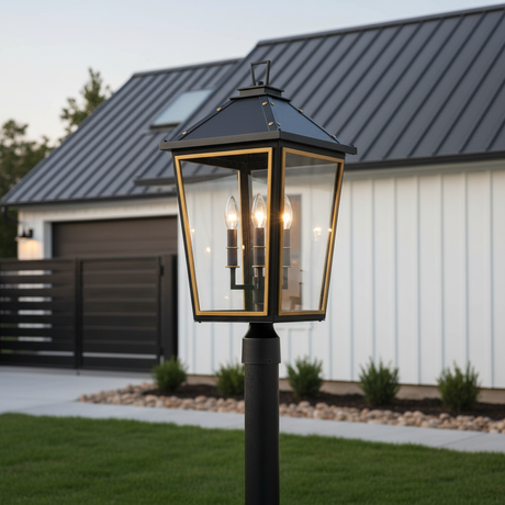 Ellington Outdoor Post Light, Black and Textured Gold - A black and gold outdoor post light illuminates a yard with a modern farmhouse in the background.
