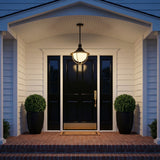 Tobin Outdoor Pendant Light 16", Black and Textured Gold globe Outdoor Hanging in a Transitional Entryway with a black paneled door and brick steps.
