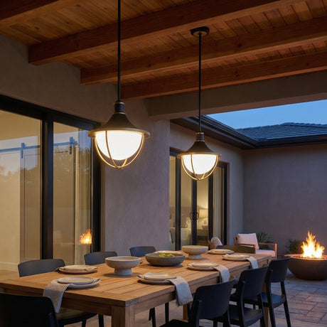 Tobin Outdoor Pendant Light 16", Black and Textured Gold globe Pendant in a Modern Outdoor with a rustic wood dining table and fire pit.