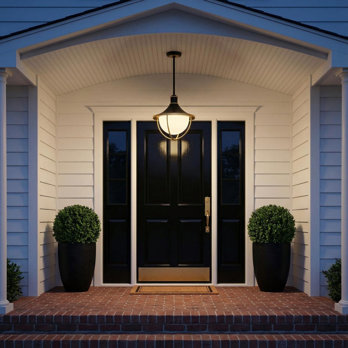 Tobin Outdoor Pendant Light 16", Black and Textured Gold globe Outdoor Hanging in a Transitional Entryway with a black paneled door and brick steps.