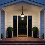 Tobin Outdoor Pendant Light 16", Black and Textured Gold globe Outdoor Hanging in a Transitional Entryway with a black paneled door and brick steps.