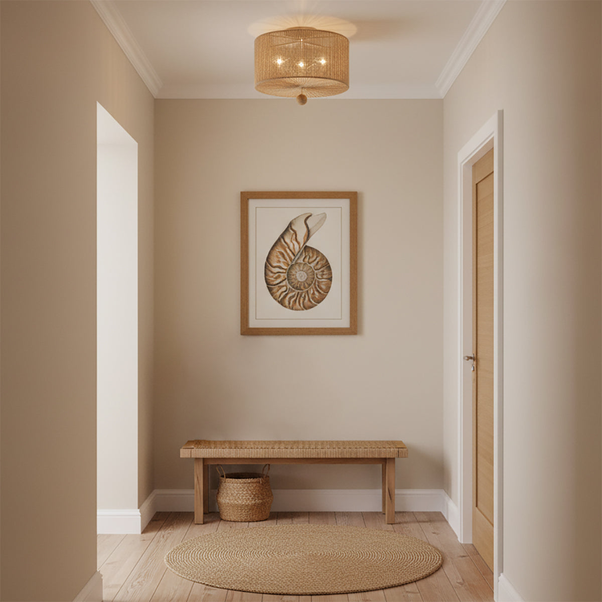 Selma Flush Mount 16, Jute and Satin Sand - A natural fiber flush mount light fixture illuminates a hallway with a nautilus shell art piece and a woven bench.