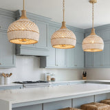 Sienna Medium Pendant 14, Rattan and Soft Brass for Coastal home with Gray Siding
