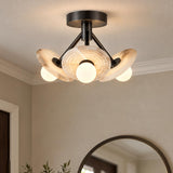 A contemporary foyer with the Bren LED Semi-Flush 13", Urban Bronze and Alabaster fixture mounted on the ceiling above a round dark mirror.