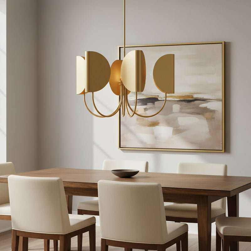 Nico 5 Light Chandelier in Antique Brass is 32" wide and shown in a modern dining room above a rectangular table with seating for six.