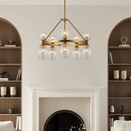 Elle Chandelier 26", Brushed Brass and Clear Glass shown in a living room with a marble fireplace and arched book shelves.