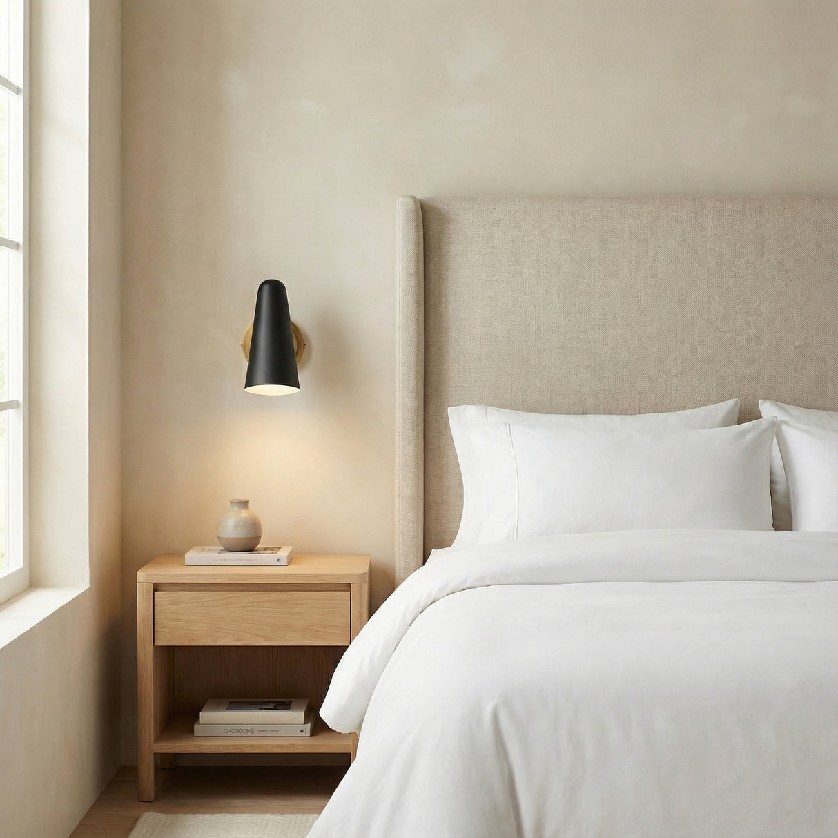 Roy Pivot Wall Sconce, Matte Black and Brass geometric Wall Sconce in a Modern Bedroom with a light wood nightstand.