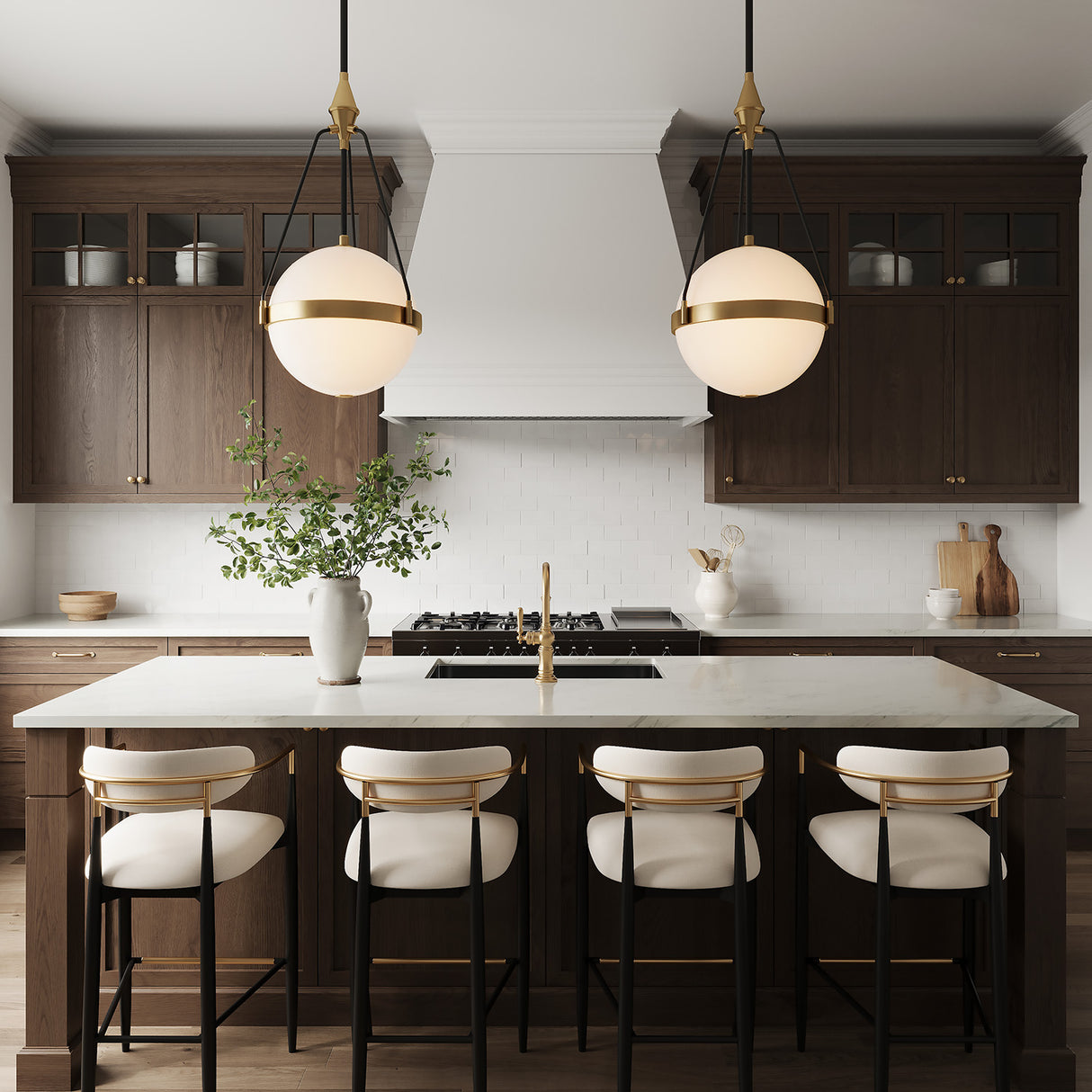 Darcy 18" pendant lights with milk glass and aged brass / black details are hung above a marble kitchen island in a classic large kitchen with dark walnut cabinetry and luxe Arhaus style counter stools. 