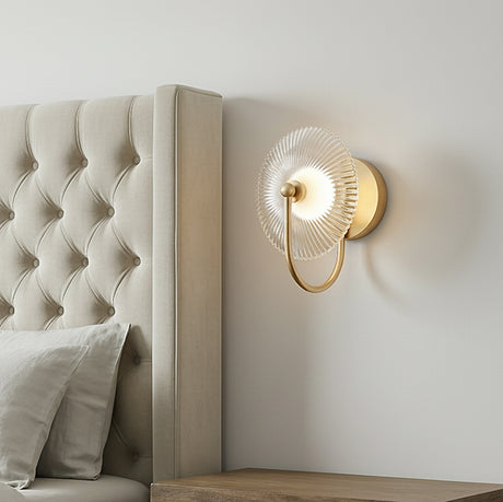 Ivan LED Curved Arm Wall Sconce, Brushed Brass geometric Wall Sconce in a Transitional Bedroom with a tufted upholstered headboard.