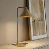 Juno Table Lamp, Brushed Brass styled in a Modern Living Room with stone surface details