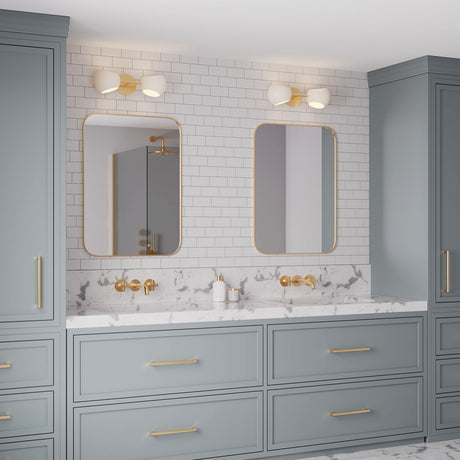 Double vanity with french blue cabinets and aged brass hardware, featuring Flynn 2-light sconce above the mirrors in white with aged brass finish.