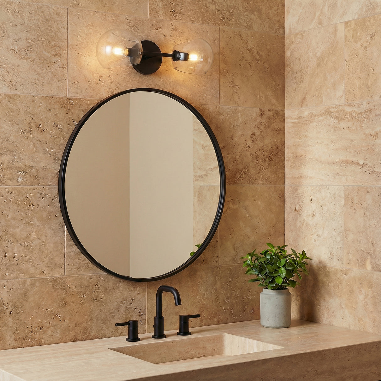 Flynn 2 Light Wall Sconce, Matte Black with Clear Glass styled in a Modern Bathroom with travertine tile.