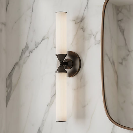 Blain LED Wall Sconce 22", in Urban Bronze finish, shown next to a vanity mirror with a marble slab backsplash.