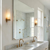 Gracy 2 Light Wall Sconce, Vintage Brass and Alabaster geometric in a Transitional Bathroom with a white marble double vanity.