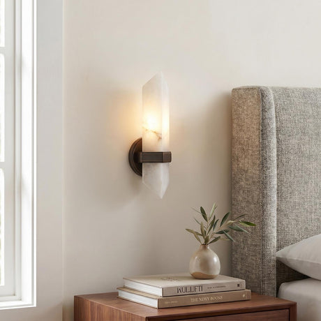 Gracy 1 Light Wall Sconce, Urban Bronze and Alabaster geometric wall sconce in a Contemporary Bedroom with a grey textured headboard.
