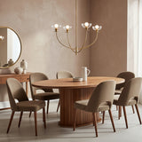 Bella 4 Light Chandelier 26" wide, in Brushed Brass finish, hung in a neutral taupe dining room above a modern oval wooden table with seating for six. 