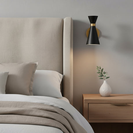 Aiden Pivot Wall Sconce, Matte Black and Antique Brass - Wall sconce in a bedroom setting as an adjustable reading light.