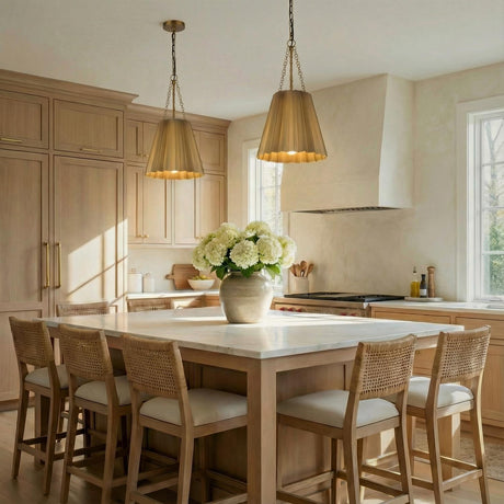 Antique Brass geometric pendant in a Transitional Kitchen with a white marble island and woven bar stools.