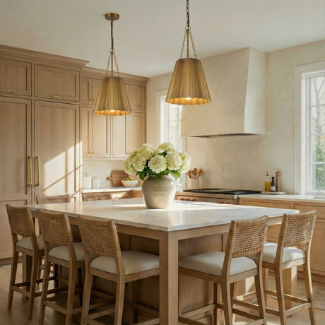 Antique Brass geometric pendant in a Transitional Kitchen with a white marble island and woven bar stools.