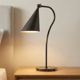 Faye Adjustable Table Lamp, Old Bronze geometric Table Lamp in a Modern Bedroom with a light wood nightstand and upholstered headboard.