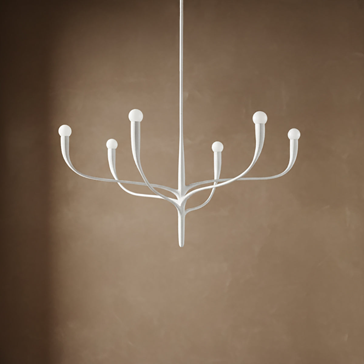 Anita 6 Light Chandelier 37", White Plaster finish, on a textured brown backdrop.