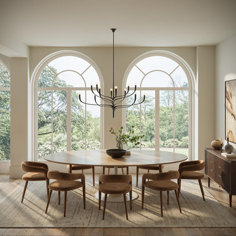 Anita 12 Light Chandelier is 52" wide and finished in Antique Iron shown in a grand dining room with a large oval table and arched windows.