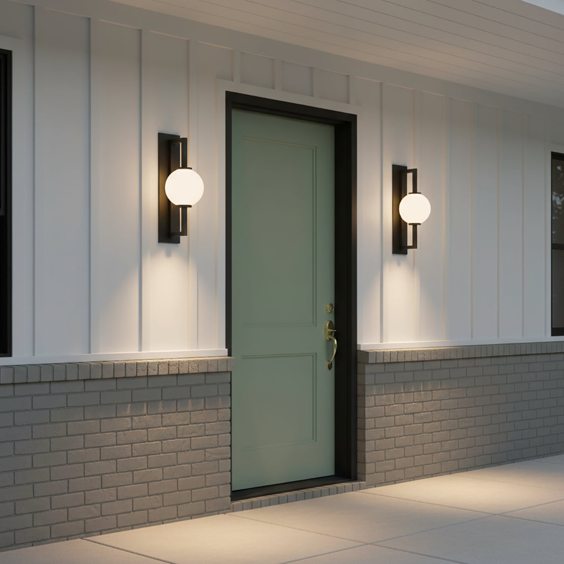 Gus Outdoor Wall Light, Large 24" Textured Black - Two globe MCM wall lights flanking a green front door on a ranch style home.