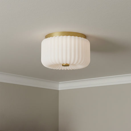 Dora Flush Mount 10, Aged Brass with Opal Glass - Flush mount light with a ribbed opal glass shade and aged brass accents affixed to a white ceiling.