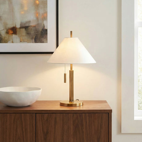 Ennie Table Lamp, Vintage Brass styled in a Transitional Living Room with a wood console table.