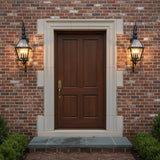 Ashford Outdoor Wall Light, Medium 40" Black - Two 40" tall lantern sconces flanking a brown front door on a brick facade.