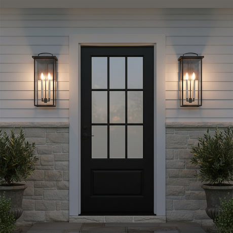 Sullivan Outdoor Wall Light, Large 22" Bronze - Symmetrical view of a black door flanked by two bronze wall lights