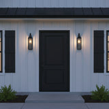 Bedford Outdoor Wall Light, Small 18" Antique Black Iron - Two black sconces flanking a black front door, on a modern farmhouse style home with black metal roof.