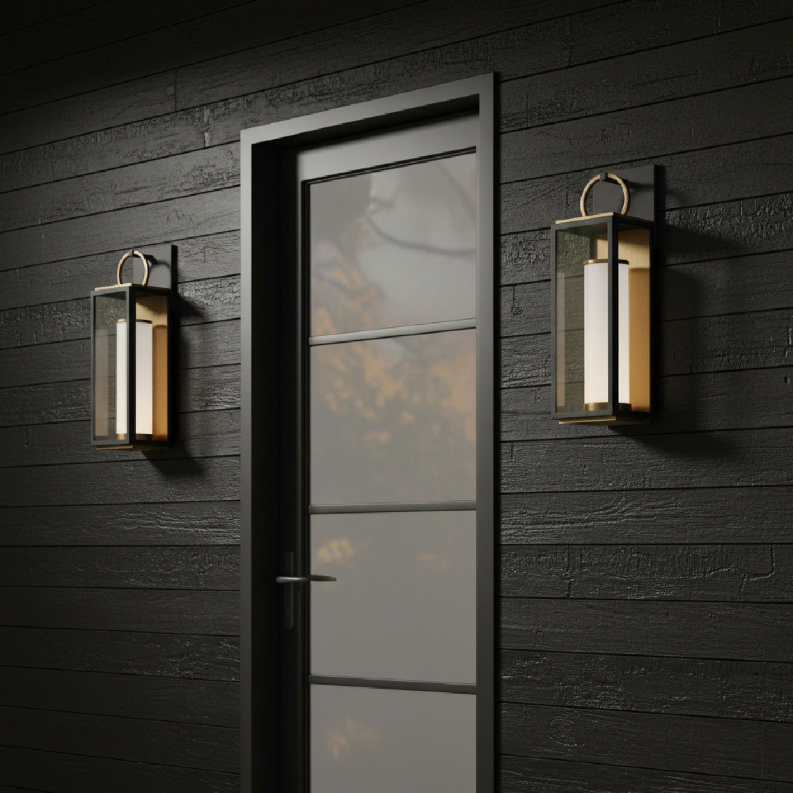 Dark walls and wooden door with glass panels flanked by two Waverly LED Outdoor Wall Lights, Small 18" in Black with Vintage Brass Accents.