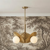 Lydia 3 Light Pendant 21", Brushed Brass and Opal Glass scalloped Chandelier in a Transitional Living Room with scenic toile wallpaper.