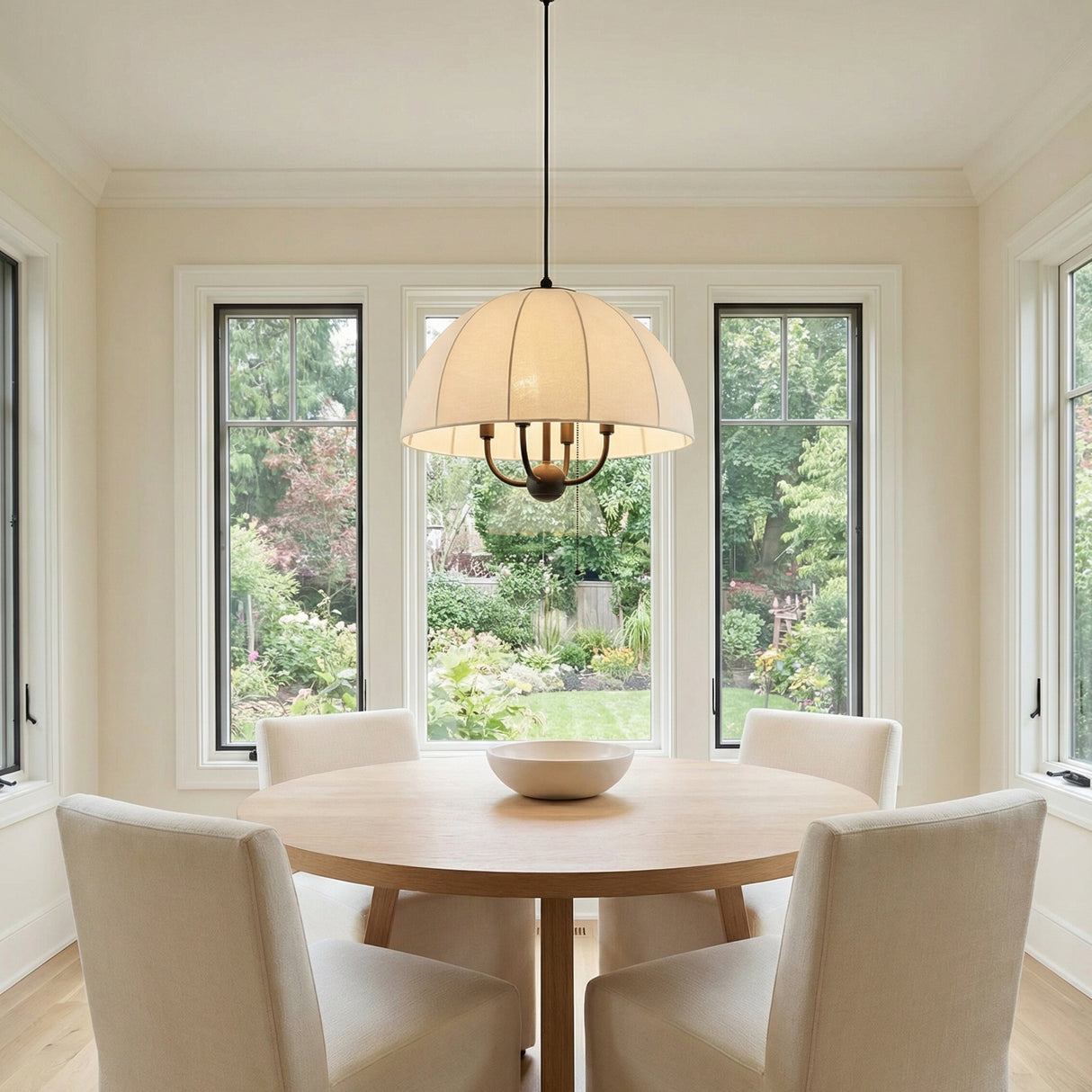 Alysa Cream Fabric/Bronze geometric pendant in a Transitional Dining Room with a light wood table.