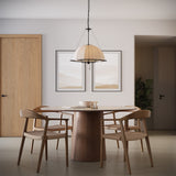 Trudy 4 Light Extra Large Pendant, Matte Black with Fabric Shade, is shown above a modern, round, walnut dining table with four chairs.