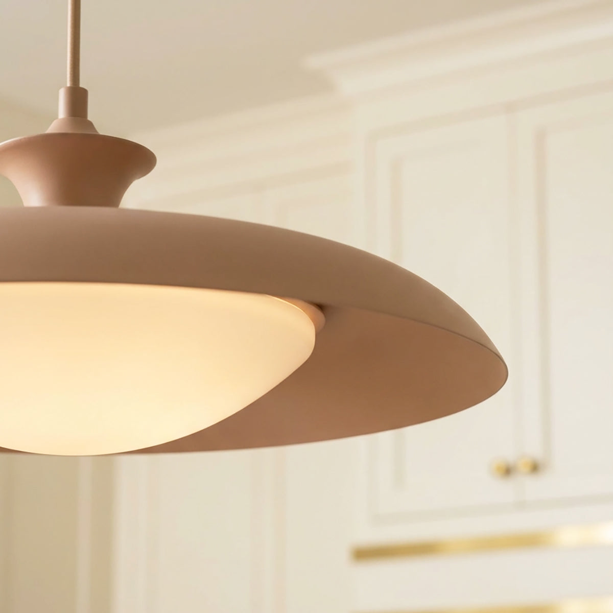 Mabel Metal Pendant 15, Blush with Opal Glass styled in a Modern Kitchen with cream cabinets.