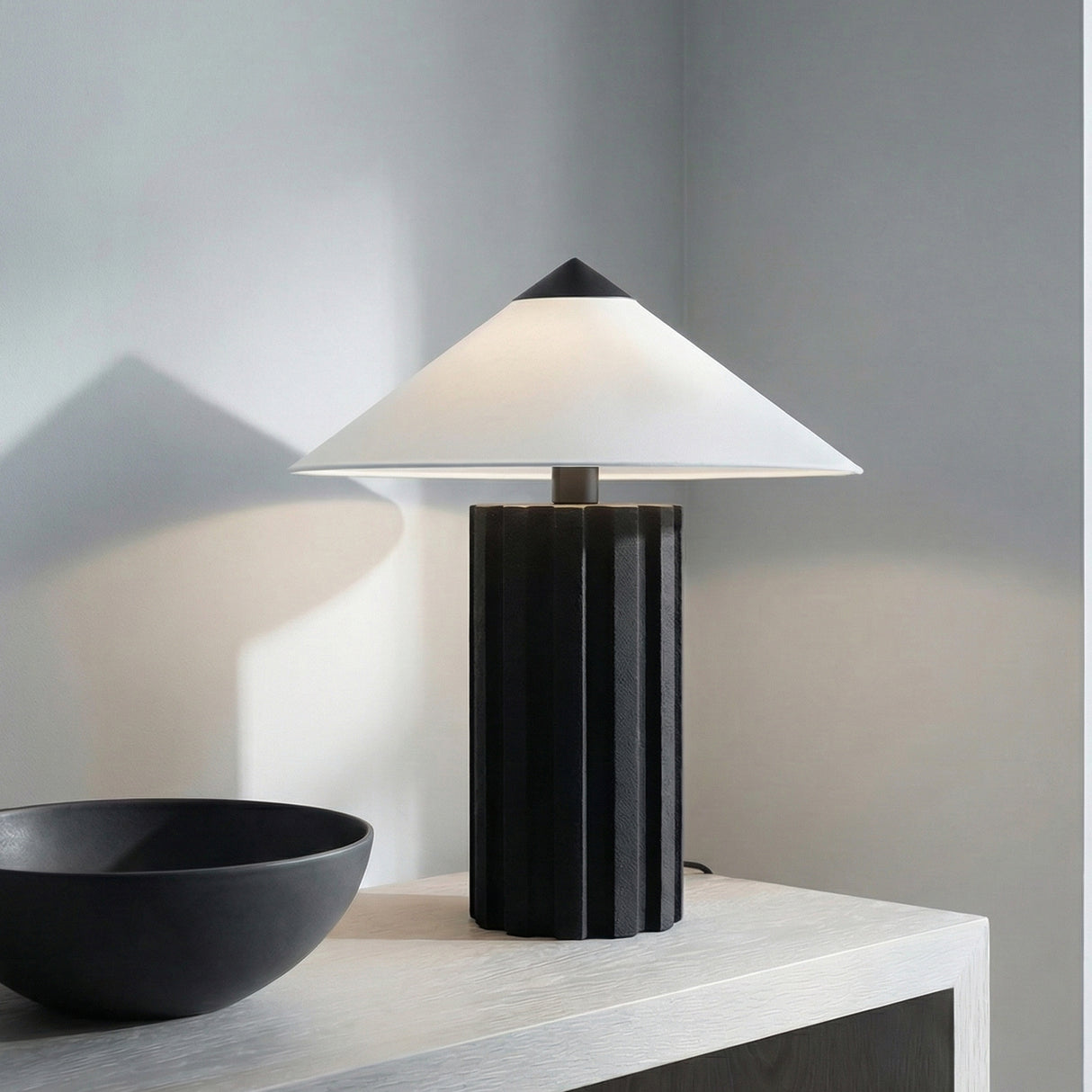 Lee Table Lamp, Textured Black geometric Table Lamp in a Modern Living Room with a light wood cabinet.
