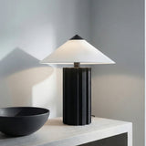 Lee Table Lamp, Textured Black geometric Table Lamp in a Modern Living Room with a light wood cabinet.