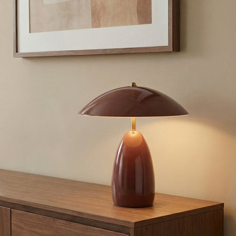 Aubrey LED Table Lamp, Maroon styled in a Modern Living Room with a wooden credenza and neutral walls.