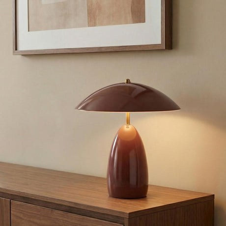 Aubrey LED Table Lamp, Maroon styled in a Modern Living Room with a wooden credenza and neutral walls.