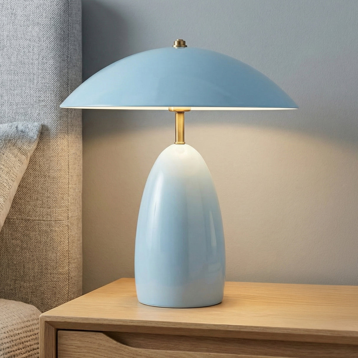 Aubrey LED Table Lamp, Baby Blue geometric Table Lamp in a Mid-Century Bedroom with a wooden nightstand and gray upholstered headboard.