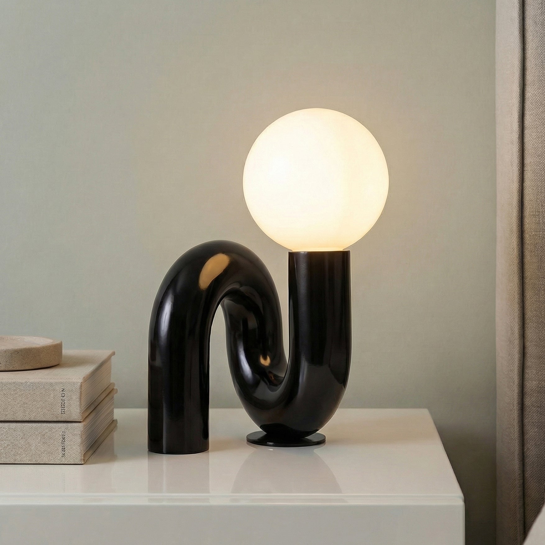 Mimi Petit Table Lamp, Glossy Black styled in a Modern Bedroom with a white lacquer nightstand.
