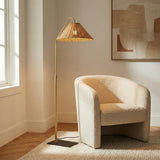 Fiona Floor Lamp, Aged Brass and Rattan woven floor lamp in a Transitional Living Room with a cream bouclé chair.