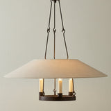 Dawson Pendant 25, Bronze with Linen Shade styled in a Transitional Living Room with textured walls.