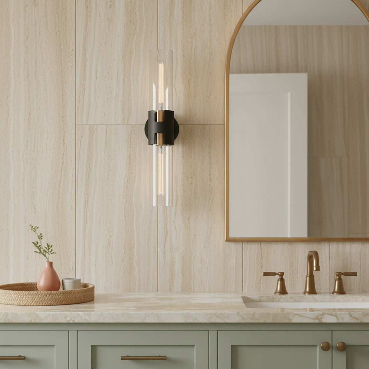 James 2 Light Wall Sconce 26, Black and Patina Brass - Bathroom scene with wall sconce, arched mirror, and sage green vanity.